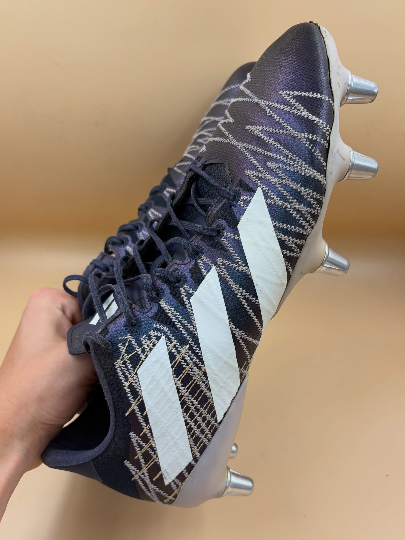 Dark Adidas X boot with white stripe detailing