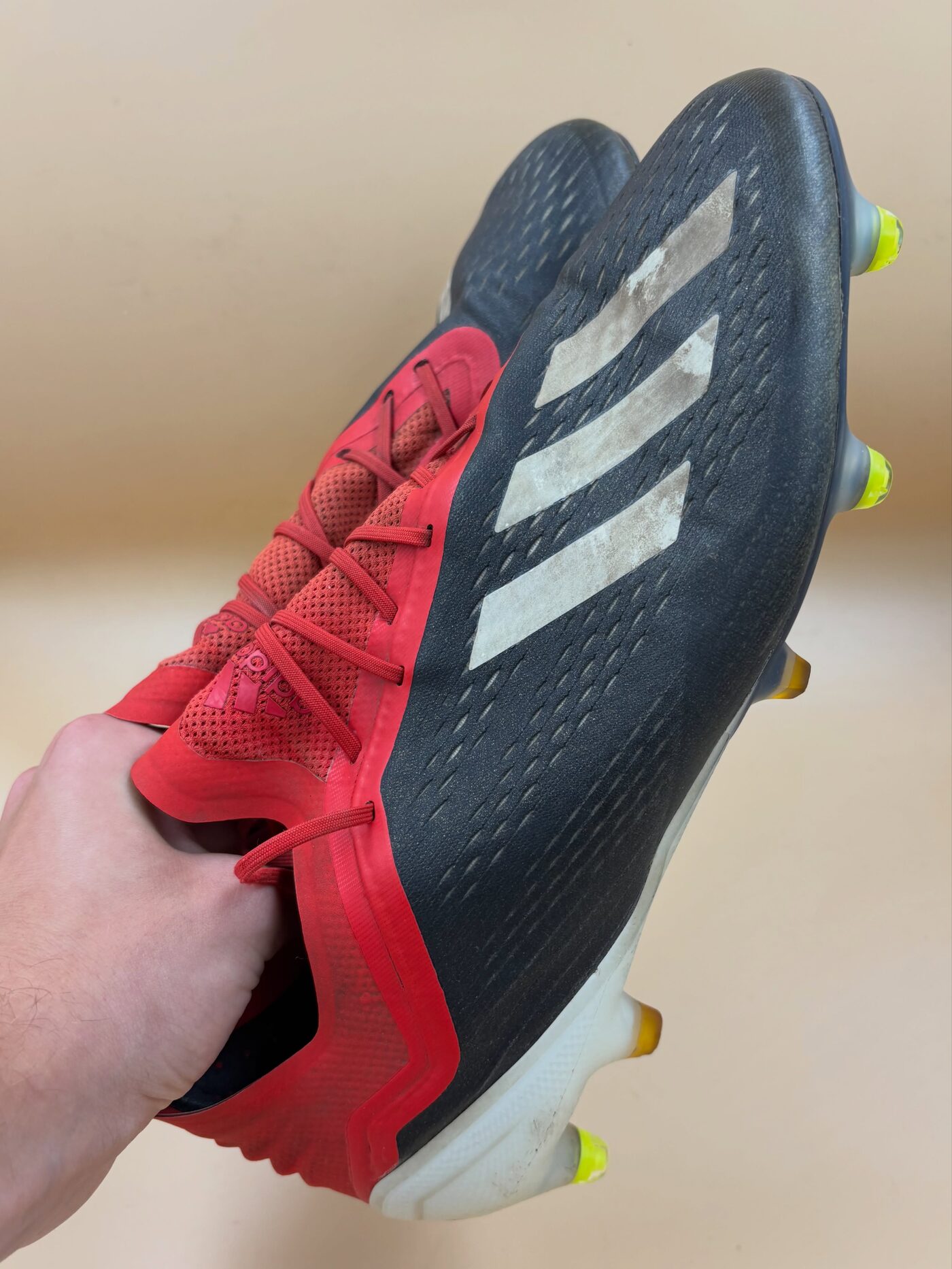 Red and black Adidas X boot after repair