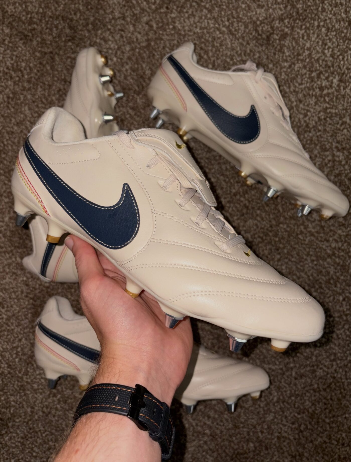 Pair of white Tiempo boots after stud conversion